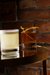 Pisco sour cocktail - whiskey with lime, egg white, sugar syrup in glass on dark background. Space for text