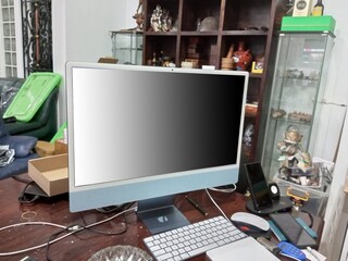 A desktop PC mounted on a workbench which looks dirty and untidy