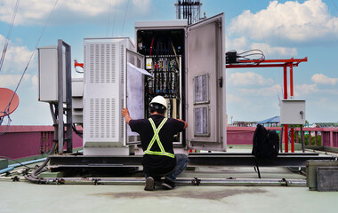 Electrical engineers inspect the electrical systems at the equipment Control cabinet used with 5G...