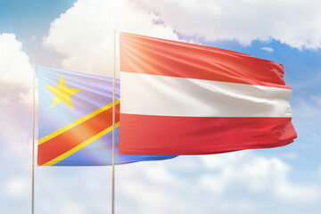 Sunny blue sky and flags of austria and dr congo