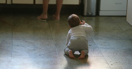 Baby crawling on kitchen floor