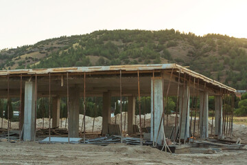 construction site of a house in turkey against the backdrop of mountains. erection of a reinforced...