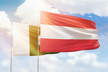 Sunny blue sky and flags of austria and pakistan