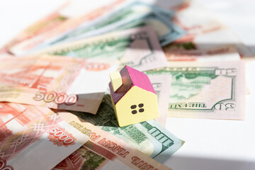toy house on banknotes, buying your own home, mortgage, symbol of material well being.Buying a house or mortgage concept. Real estate price. Toy house on russian banknote background