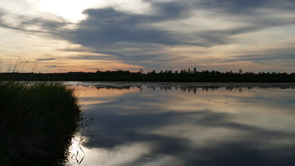 See bei Sonnenuntergang mit Bäumen und Reflexionen des Wasser
