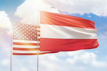 Sunny blue sky and flags of austria and usa