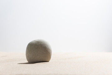 Stone on sunny beach