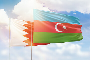 Sunny blue sky and flags of azerbaijan and bahrain