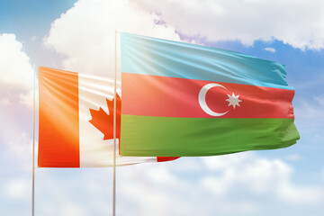 Sunny blue sky and flags of azerbaijan and canada