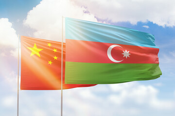 Sunny blue sky and flags of azerbaijan and china