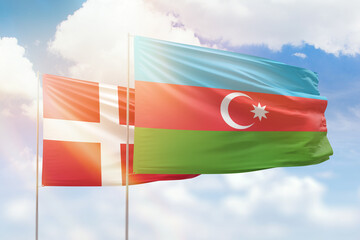 Sunny blue sky and flags of azerbaijan and denmark