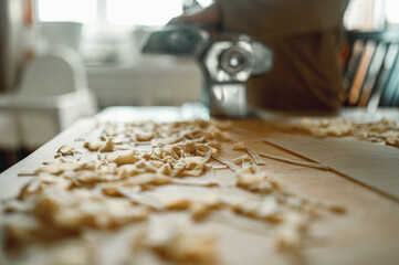 dad cooks homemade noodles with the kids, making tagliatelle with pasta machine on kitchen table