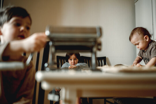 Dad Cooks Homemade Noodles With The Kids, Making Tagliatelle With Pasta Machine On Kitchen Table