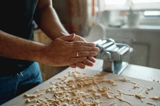 Dad Cooks Homemade Noodles With The Kids, Making Tagliatelle With Pasta Machine On Kitchen Table