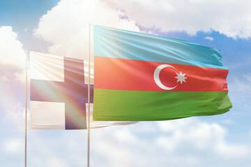 Sunny blue sky and flags of azerbaijan and finland