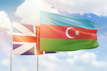 Sunny blue sky and flags of azerbaijan and great britain