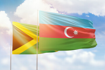 Sunny blue sky and flags of azerbaijan and jamaica