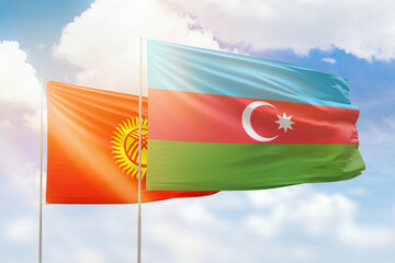 Sunny blue sky and flags of azerbaijan and kyrgyzstan