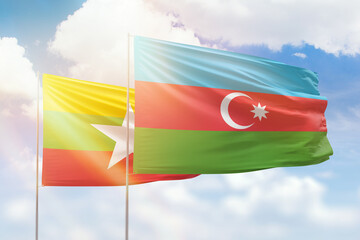 Sunny blue sky and flags of azerbaijan and myanmar