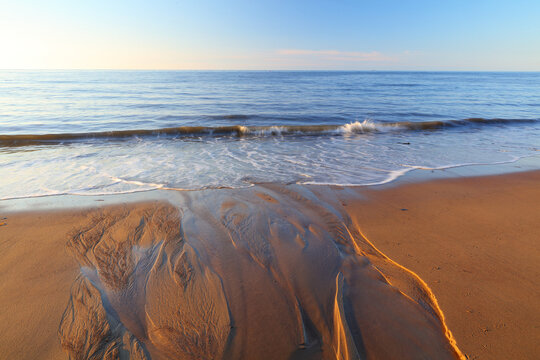 View Of The North Sea With Sand Patterns In The Foreground, Runswick Bay, North Yorkshire, England, UK.