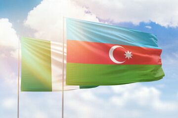 Sunny blue sky and flags of azerbaijan and nigeria