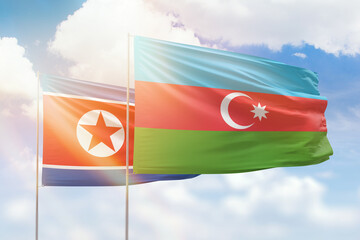 Sunny blue sky and flags of azerbaijan and north korea