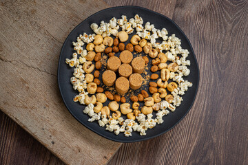 June party: Peanut candy, popcorn, peanuts and paçoca on rustic wooden background