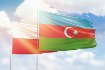 Sunny blue sky and flags of azerbaijan and poland