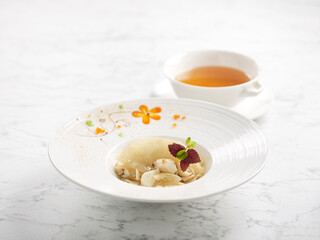 Sauteed Superior Shark’s Fin with Fresh Crab Meat served with Superior Broth served in a bowl isolated on grey background