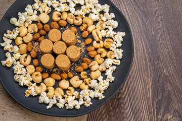 June party: Peanut candy, popcorn, peanuts and paçoca on rustic wooden background