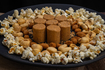 June party: Peanut candy, popcorn, peanuts and paçoca on rustic wooden background