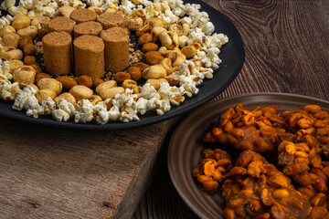 June party: Peanut candy, popcorn, peanuts and paçoca on rustic wooden background