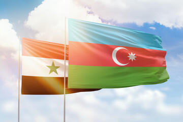 Sunny blue sky and flags of azerbaijan and syria