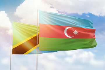 Sunny blue sky and flags of azerbaijan and tanzania