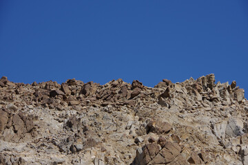 Rough desert mountain terrain and blue sky in California