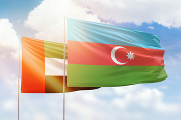 Sunny blue sky and flags of azerbaijan and uae
