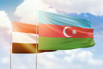 Sunny blue sky and flags of azerbaijan and yemen