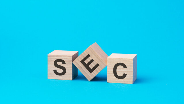 sec text on wooden blocks, business concept, blue background