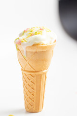 ice cream cone on white background and sugar particles on it