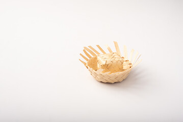 Mini straw hat used in Junina party decoration in Brazil, placed on white background, selective focus.