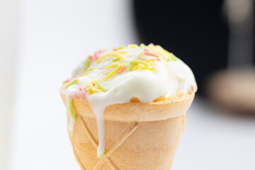 ice cream cone on white background and sugar particles on it