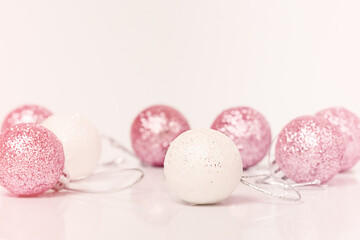 Christmas toys in white and pink on a light background. Christmas theme.