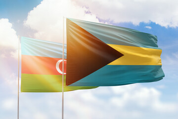 Sunny blue sky and flags of bahamas and azerbaijan