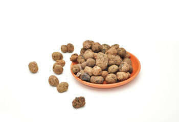 scattered expanded clay with a ceramic dish