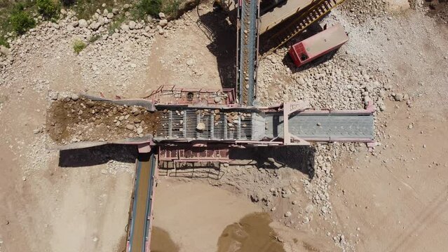 Top view of a sieving machine classifying aggregates in a screening plant. Mining industry equipment
