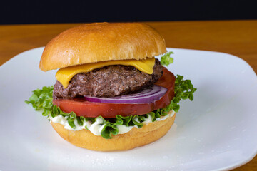 cheese burger on a broiche roll with a pickle