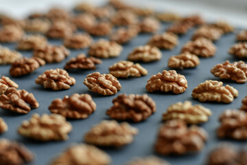 Open walnuts on grey background. Selective focus.