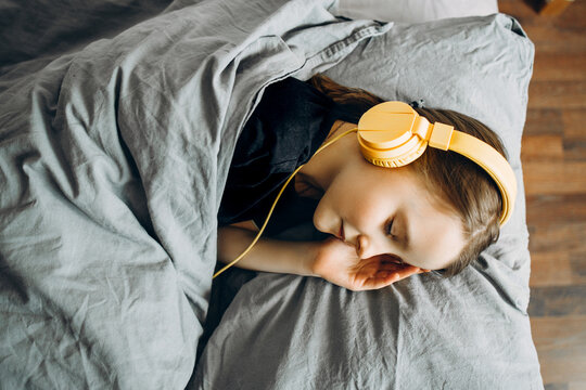 Girl fell asleep in bed while listening to a podcast