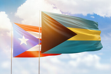 Sunny blue sky and flags of bahamas and puerto rico