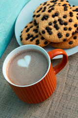 Mug of cocoa served with biscuits